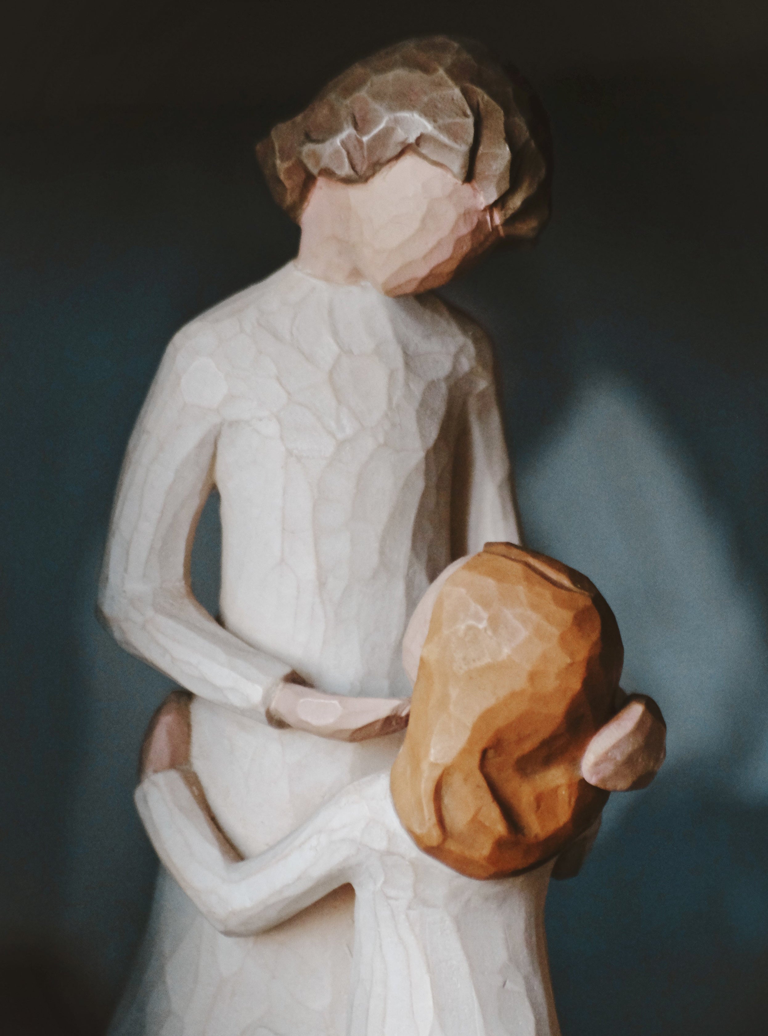 A wooden figurine of mother and child